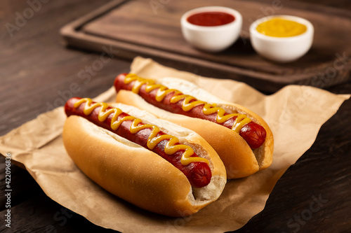 Hot dog with ketchup and yellow mustard.