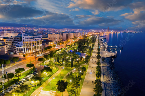 Evening panorama of Cyprus. Night city of Limassol. Embankment in Cyprus. City Limassol from bird eye view. Evening embankment is illuminated by lanterns. View of evening city Limassol. Cyprus travel