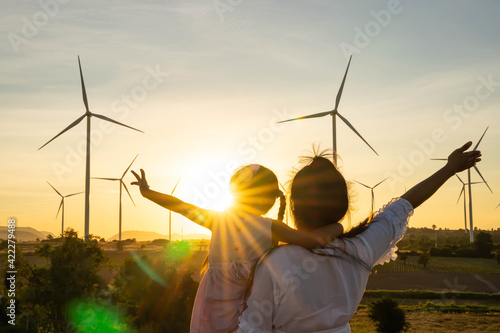 Wind turbines are alternative electricity sources, the concept of sustainable resources, People in the community with wind generators turbines, Renewable energy