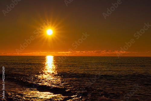 Yellow sunset on the background of the sea