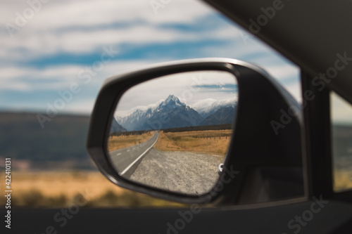 view of mount cook new zealand in the rear view mirror. end of journey. traveling is over