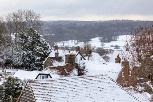 View over cottage rooftops and High Weald landscape in winter snow, Burwash, East Sussex, England, United Kingdom, Europe