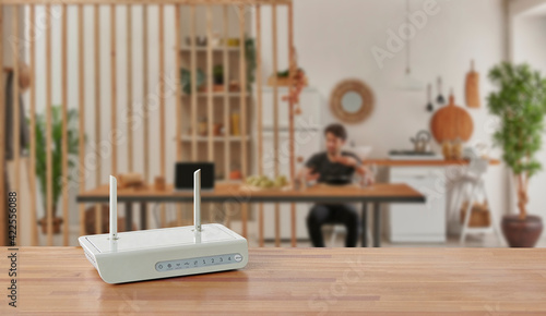 Modem and router box on the table and living room background blur concept.