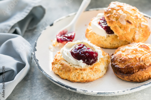 Traditional British Scones with clotted cream, raspberry jam.