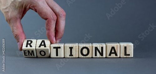 Rational or emotional symbol. Psychologist turns wooden cubes and changed the word 'rational' to 'emotional'. Beautiful grey background. Psychological and rational or emotional concept. Copy space.