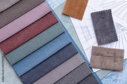 House plans and fabric samples on color background, closeup