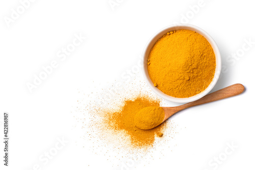 Flat lay (top view) Turmeric (Curcuma longa Linn) powder in white bowl and wooden spoon isolated on white background.