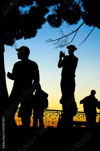 People watching the sunset in a viewpoint of Lisbon