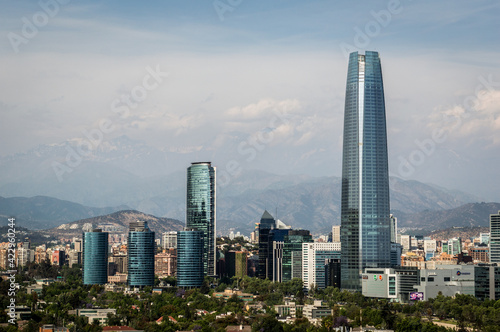 Skyline of modern buildings at financial district with The Andes mountain range in the back.