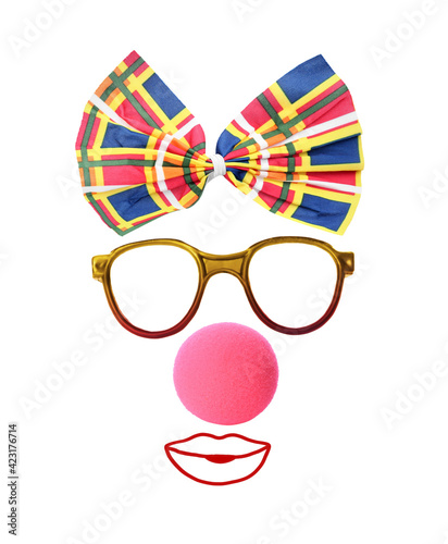 Funny clown's face made of bow, eyeglasses and foam nose on white background