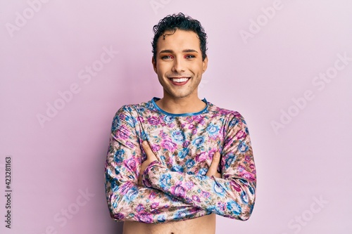 Handsome man wearing make up wearing fashion clothes happy face smiling with crossed arms looking at the camera. positive person.