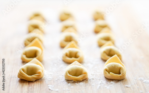 Fresh Tortellini pasta on a wooden board