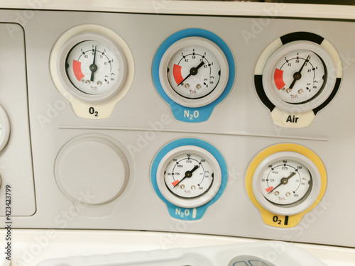 Gas pressure analog manometer gauges on anesthetic machine: oxygen, laughing gas, air.