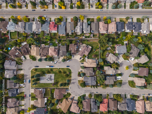 Calgary, Alberta, Canada, aerial top down view of houses and streets in beautiful residential neighbourhood during fall season.