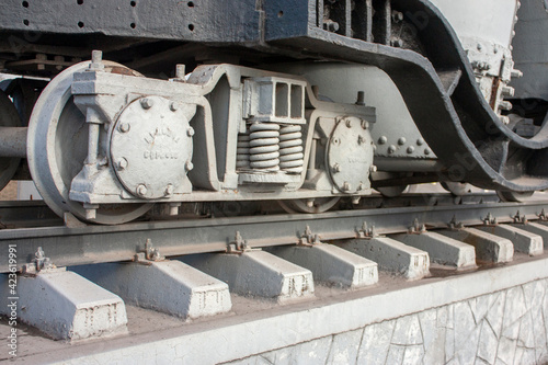 Carriage bogie, perspective view. The main element of the carriage running gear, close-up. A wagon bogie on a railway track. Fragment of the railroad track.