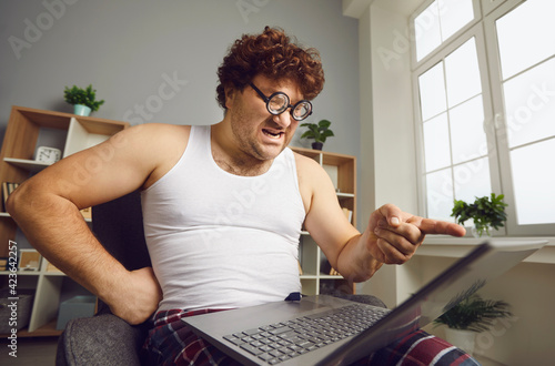 Someone's Wrong On The Internet. Funny angry man points finger at laptop screen. Aggressive opponent, online fight, discussing politics, disagreement, computer bug error, slow wifi connection concept