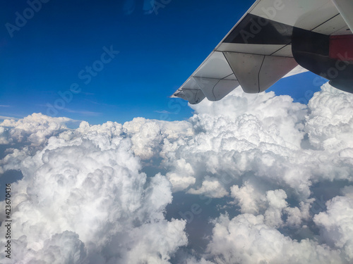 Stock photo of beautiful aerial view seen through window. Skyscape with clouds from the plane window at Bangalore Karnataka India.