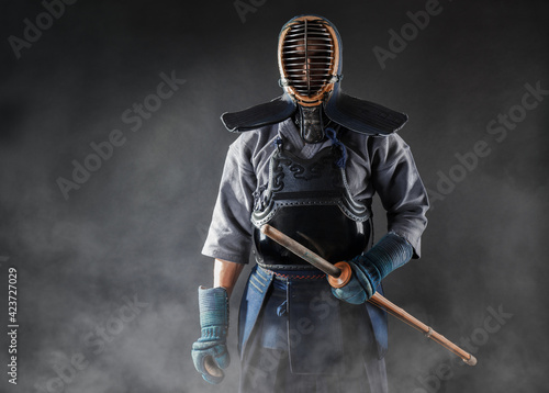 Portrait of Kendo master standing in fighting stance.
