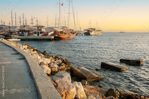 Stylish luxury yachts, ships and sailing boats moored on Bodrum Marina, Turkey, on the sunset.