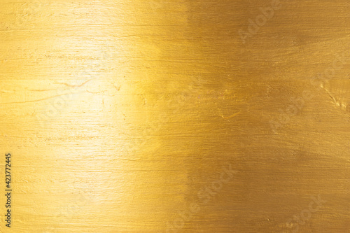 Gold texture background with yellow foil luxury shiny shine glitter sparkle of bright light reflection on golden surface