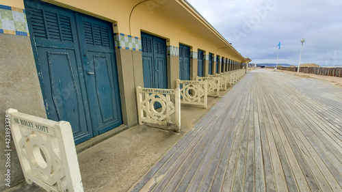 Deauville boasts sandy beach boardwalk and beach huts wooden in Normandy with the name of American star actor