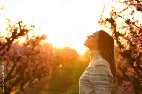 Woman breathing at sunrise in a field