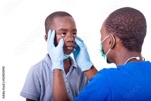 doctor examining the eyes of a little boy.