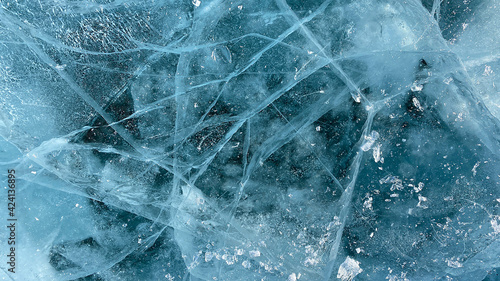 Amazing unique pattern of frozen Lake Baikal. View from above. Blue transparent clear smooth ice with deep cracks