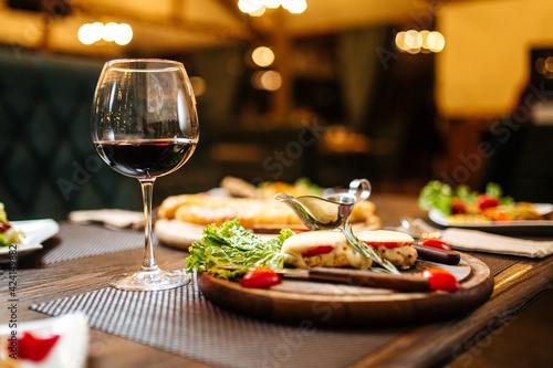 Evening celebration dinner with wine on blurry background