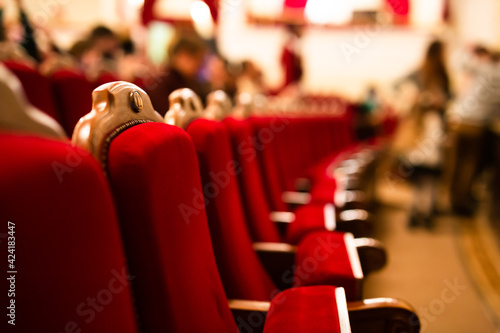 red velvet armchairs in an empty theater hall