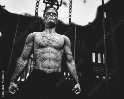 Classic film style black and white of Frankenstein's monster coming alive in Frankenstein's lab