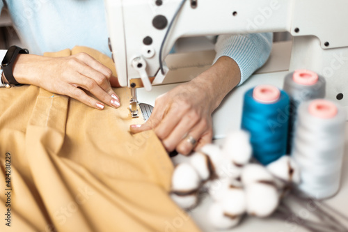 Workplace behind a sewing machine. Hand-sewn, organic sustainable fabrics.