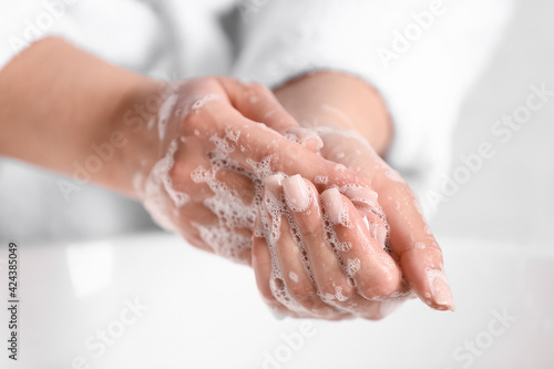 Woman washing hands in bathroom