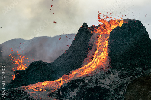 Volcanic eruption in Iceland, lava bursting from the volcano. Smoky mountain. 