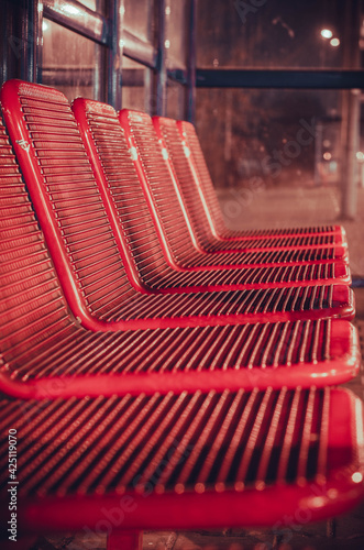 Red seats at the train station.
