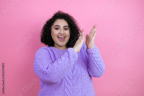 Young beautiful woman wearing casual sweater over isolated pink background clapping and applauding happy and joyful, smiling proud hands together