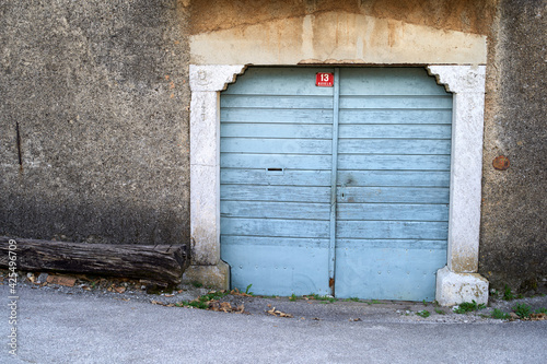 Old wooden blue door in Kras house in Novelo village on karst, carso.