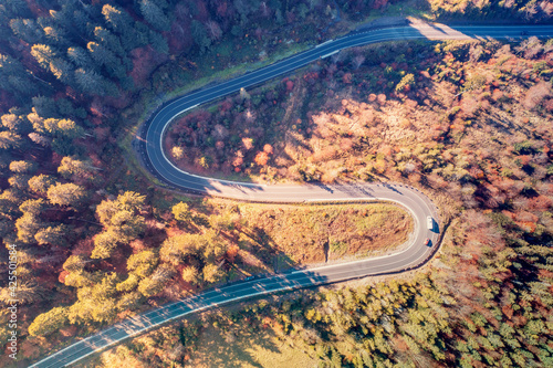 Aerial view of hairpin turns on a mountain road in autumn. Beautiful landscape of the Carpathian Mountains. Ukraine, Europe