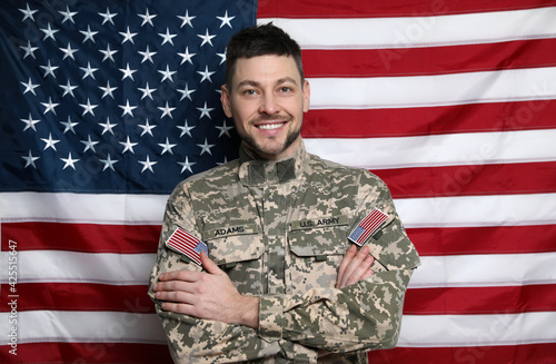 Portrait of happy cadet against American flag