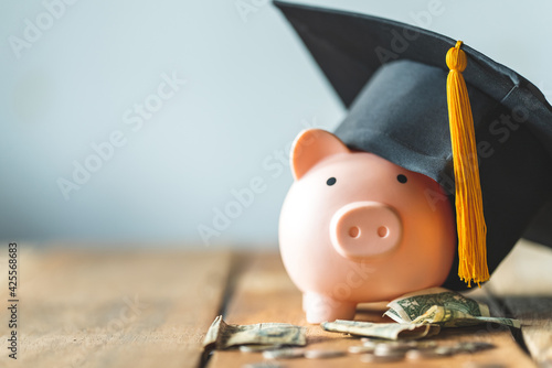 piggy bank With Graduation Cap on old wood,Money saving concept.