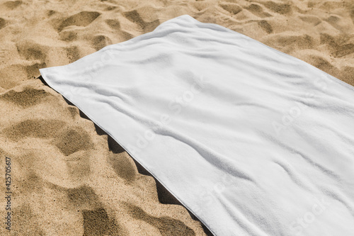 White beach towel on the sand