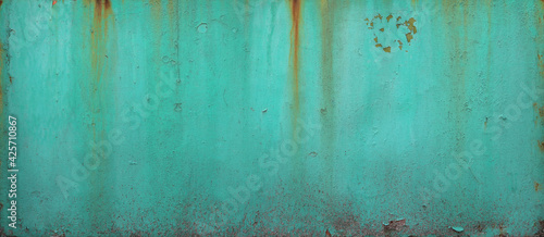 turquoise blue wall or surface of a fence of metal, with orange grooves from rust - weathered texture for the background of a steampunk wallpaper