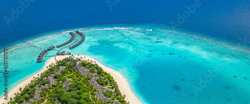 Wonderful aerial view landscape, luxury tropical resort or hotel with water villas and beautiful beach scenery. Amazing bird eyes view in Maldives, landscape seascape aerial beach in Maldives islands