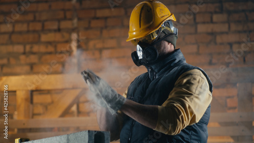 Male builder cleaning nose during work