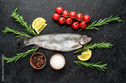 raw fish trout on a stone background.