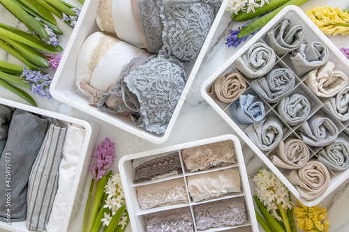 Stylish composition storage underwear organization Marie Kondo's method decorated by natural flowers