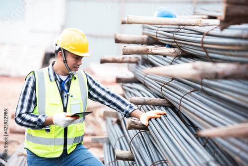 Inspectors are inspecting rebars at a construction site for rebar or reinforcement.