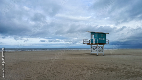 wooden hut on stilts for french lifeguards on sand beach of deauville in france