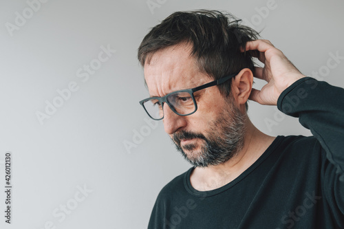 Forgetfulness - forgetful mid-adult man with eyeglasses