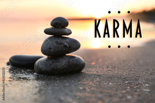 Karma concept. Stones on sand near sea at sunset